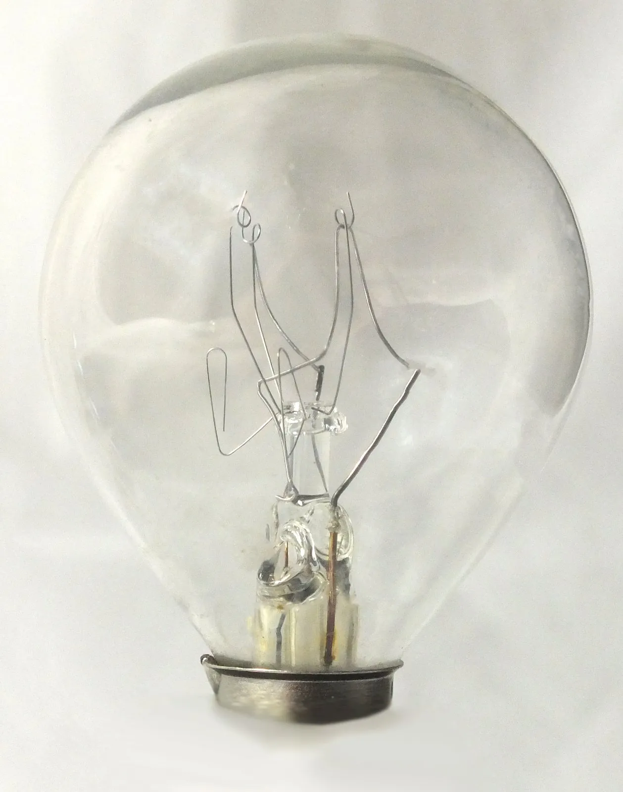 Lightbulb Interior: Clear bulb with the filament gone, leaving bent support wires in sharp focus.