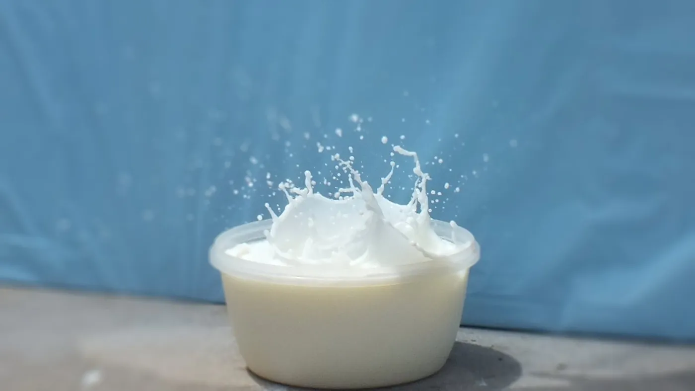 Milk Splash: The splash crown caught mid-air against a blue backdrop.