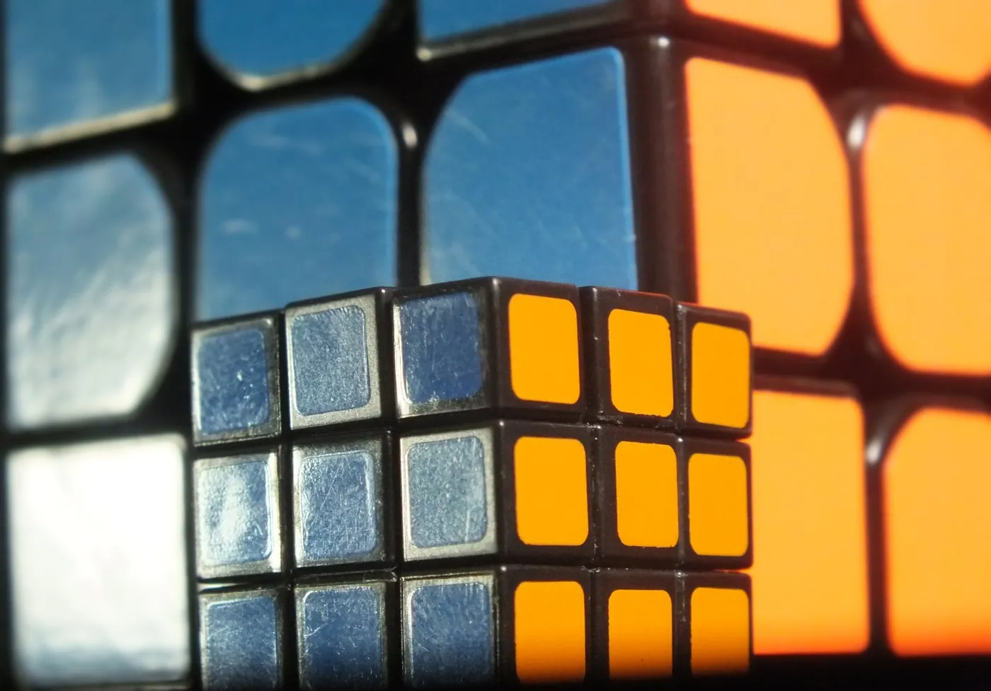 Cube Within a Cube: A small Rubik’s cube set against a giant one.